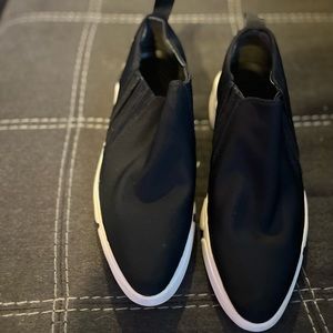 Black slide on sneakers.